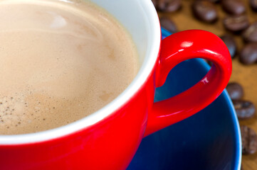 Red Coffee Cup with Frothy Latte Close-Up