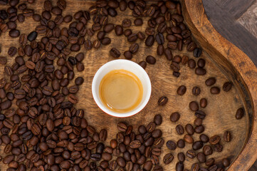 Espresso in Small Cup Amid Coffee Beans