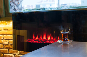 Turkish Tea by Electric Fireplace Cozy Scene