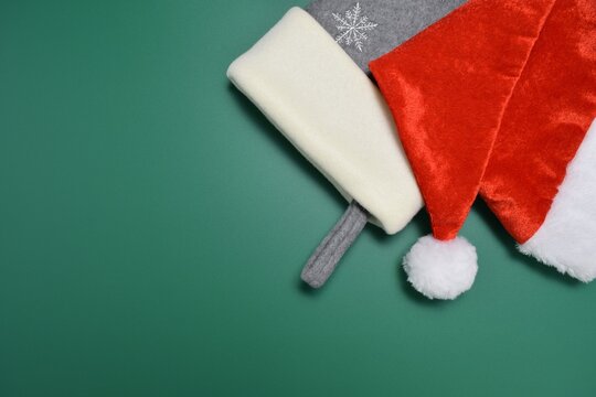Close-up of Santa's hat and stocking against a green background