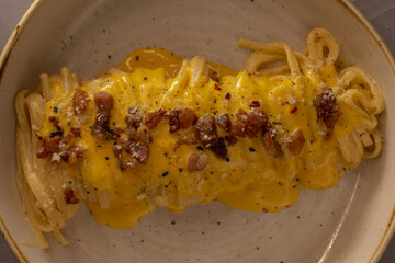 Warm pasta topped with melted cheese bits, Savory cheddar pasta combined with crispy bacon and rich...