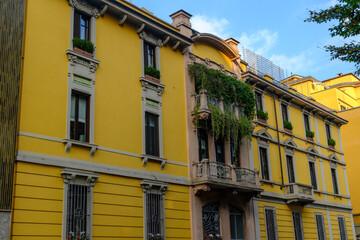 Old residential buildings along Via dei Praga in Milan, Italy
