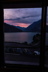 Dramatic sunset over Lake Mezzola and Pian di Spagna nature reserve with golden light reflecting on water and mountain silhouette