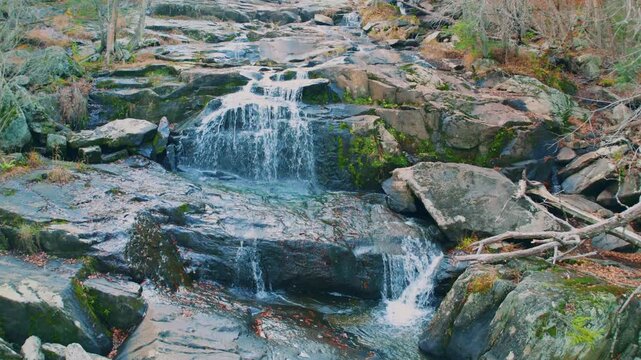 Footage of Glendale Falls, a beautiful and powerful natural waterfall in Middlefield, Massachusetts. The Glendale Brook cascades over 160 feet of rocky ledges and boulders surrounded by a lush forest 