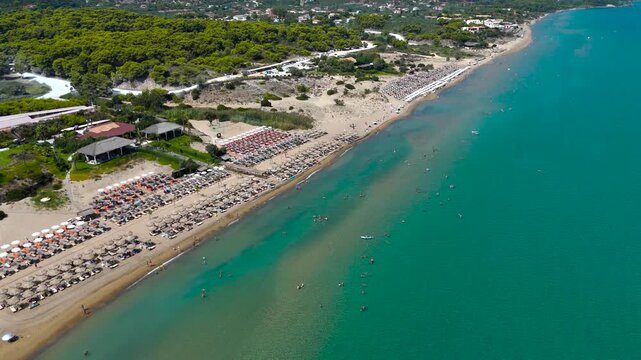4K Cinematic Drone Footage of Long Sandy Beach in Zakynthos, Greece, Colorful Umbrellas Along Turquoise Blue Sea on Clear Summer Day