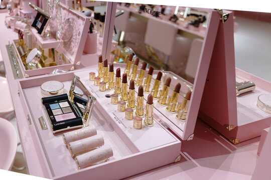 Lanc&ocirc;me 90th anniversary exhibition space featuring a pink-themed beauty counter with cosmetic displays and brand signage inside a retail environment.