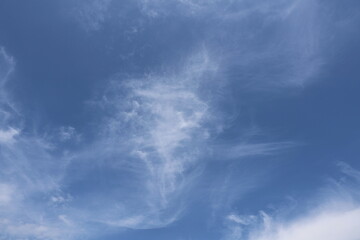 Fototapeta premium The atmosphere of the sky in summer. High-level clouds are characterized by thin, white streaks that resemble hairs, fibers, or feathers, ice crystals.The sky is full of Cirrus clouds. The sky blue. 
