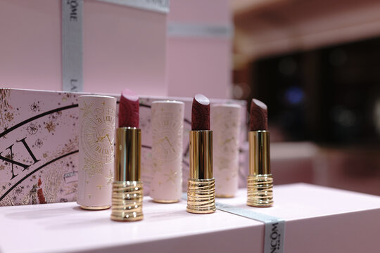 Lanc&ocirc;me 90th anniversary exhibition space featuring a pink-themed beauty counter with cosmetic displays and brand signage inside a retail environment.