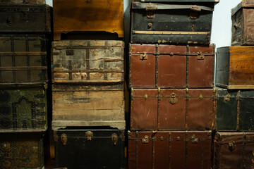 Vintage old antique trunks and wooden chests forming a multi-colored background texture, showcasing history, travel, and storage concepts in a rustic, aged collection