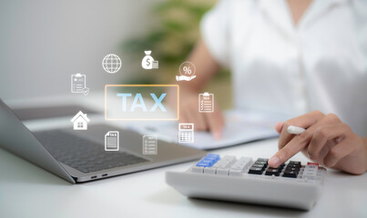 Close up hands calculating tax with calculator beside laptop showing digital tax icons accounting finance planning compliance concept for business expense control and annual tax management