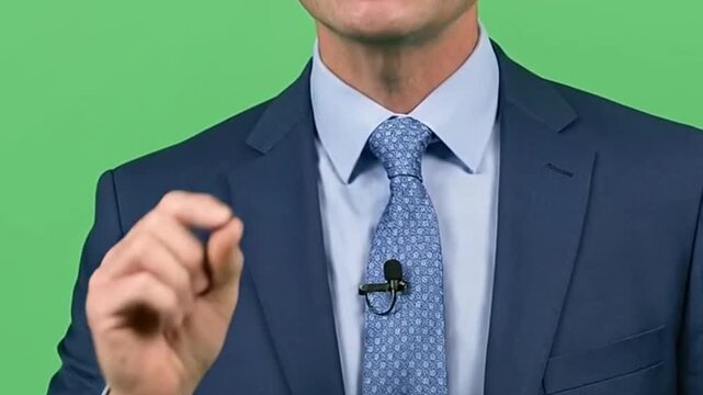 Professional presenter explaining a concept on green screen for visual effects insertion and