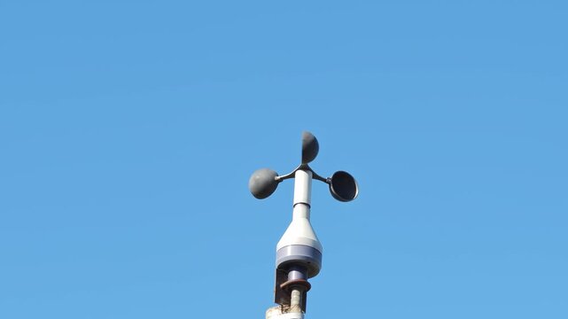 anemometer with three hemispheres for precise measurement and recording of wind speed and the background of the blue sky without 