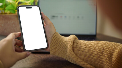 Close up of hands holding smartphone with blank white screen, perfect mobile app or UI mockup with copy space.