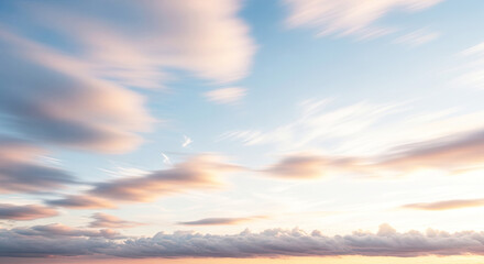 Naklejka premium A serene, pastel-colored sky with wispy clouds and a hint of a setting or rising sun, evoking a sense of calm and tranquility.