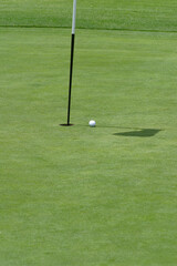 Obraz premium Los Angeles CA September 18, 2025 Golf ball enoute to its destination with flag in hole.