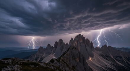 Dramatic mountain peaks under a stormy sky with lightning strikes