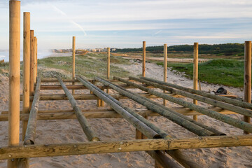 Detalhe de constru&ccedil;&atilde;o de estrutura em madeira n&oacute;rdica junto ao mar nas dunas de areia. 