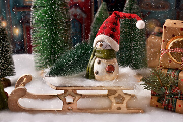 Christmas arrangement with snowman figurine  on the sled