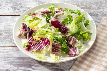Fresh Mixed Lettuce Salad On Rustic Wooden Table For Healthy Eating Concepts Weight Loss Menus Detox Recipes Or Vegetarian Lifestyle With Natural Light And Country Style Composition
