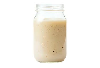 Active sourdough starter fermenting in a glass jar for baking