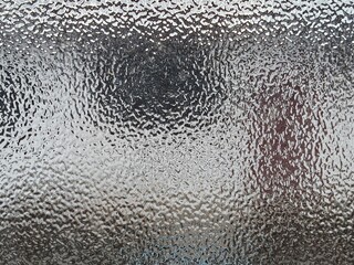 Blurred frosted glass texture. Window backdrop with shadows and reflections. Glass effect background. Abstract gradient bright light reflection and shiny rough texture surface	