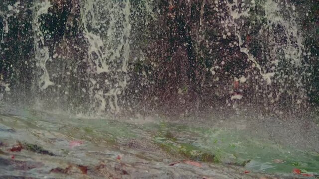 A detailed close-up shot of water splashing over rocks at Glendale Falls in Massachusetts. The footage captures the dynamic movement and texture of the cascading water, ideal for use in nature documen