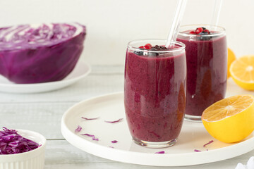 Red cabbage berry smoothie on kitchen table with white background. Healthy homemade blended drink.