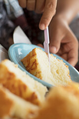 Slicing Soft Cheese Cake with Golden Crus