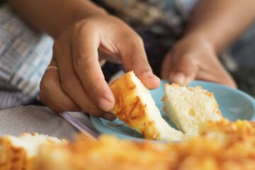 hands put pieces of cheese bread on a plate