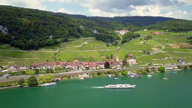 Aerial drone view of Lake Biel in summer with island and ferry boat