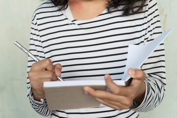 girl Focused Writing Moment in Striped Shirt