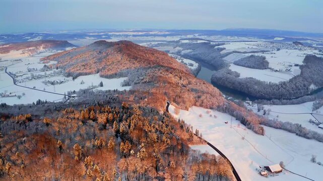 Aerial winter sunrise over Buchberg with snow covered landscape and view of the Rhine rive