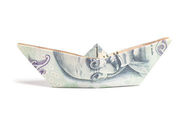 Money origami boat with One hundred rupee note (Indian currency) isolated on white