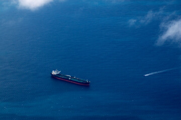 big ship container aerial view from airplane window ad sunset