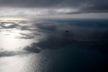 big ship container aerial view from airplane window ad sunset