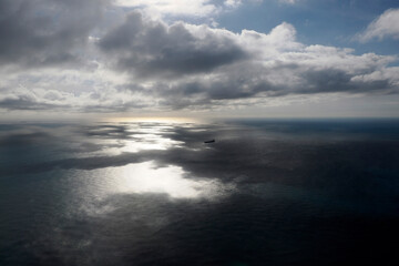 big ship container aerial view from airplane window ad sunset