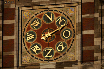 clock detail of amsterdam central station at sunset