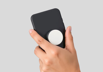 Hand holding black phone with white pop socket mockup, ai generated
