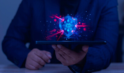 Businessman holding tablet with shield protecting folders from virus attacks. Concept of mobile cybersecurity, firewall antivirus, and data defense.