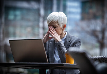 Business woman thinking of problem in outdoor cafe