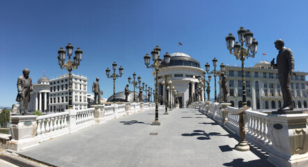 Beautiful white bridge in the center of Europe in Macedonia decorated with statues and whimsical lanterns. Sightseeing tours in summer. Historical sights conservation.