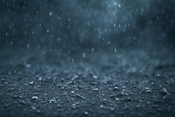 Raindrops falling on dark surface showing natural beauty