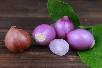 Fresh raw onions on wooden background.