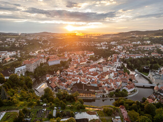Early morning light bathes the charming town of Cesky Krumlov in a golden hue. The sun rises above...