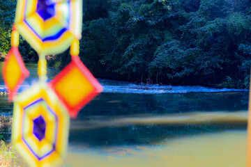 This is a Spider Web Tung, a traditional Lanna flag made of threads, used for religious ceremonies.