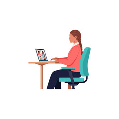 Woman working from home on a video conference call with colleagues on her laptop computer at a desk