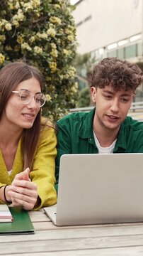 Two students working and learning together using laptop to study for university exams