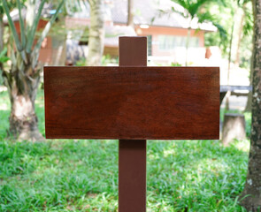 Wooden sign stand on floor in nature garden and house background.