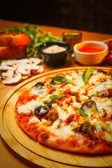 Close Up of Italian Pizza With Melted Cheese, Olives, Vegetables and Tomato Sauce