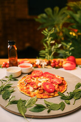 Italian Pizza With Roasted Tomatoes, Tomato Sauce, Olive Oil and Basil on Rustic Table